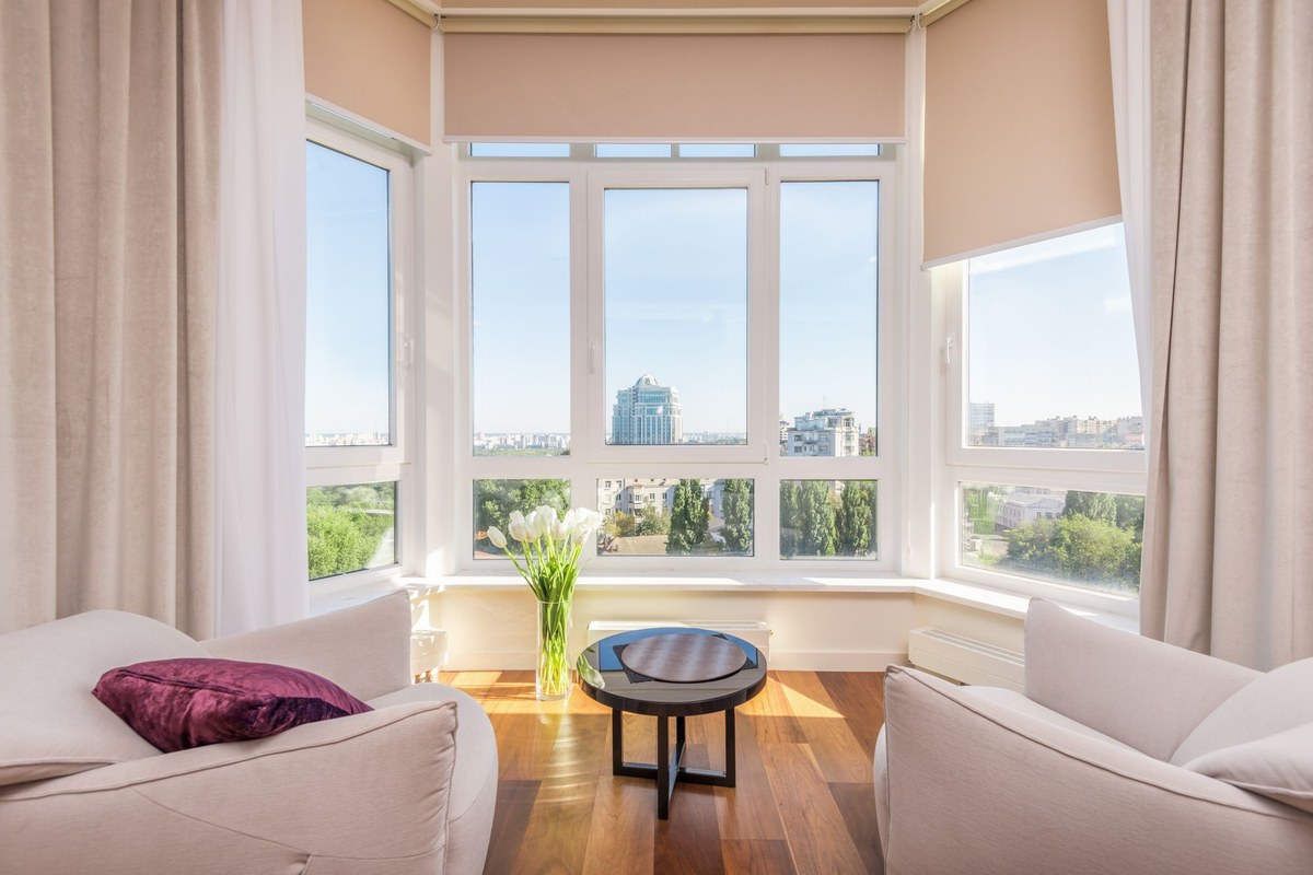 Living room bay window with a large fixed central pane and opening side sashes