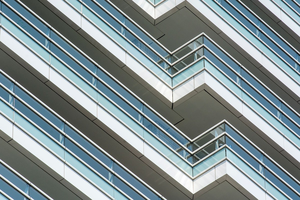 Balconies with glass railings on a modern building facade