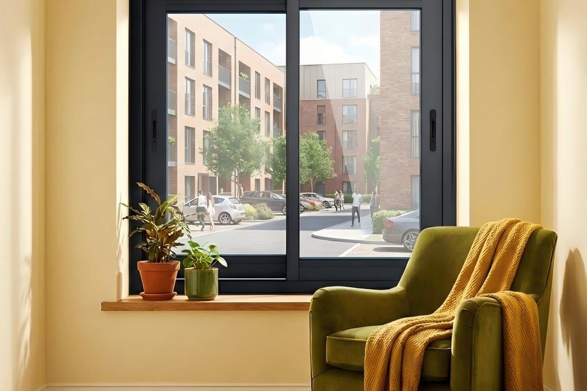 Black aluminum sliding window with a slim frame in a cozy reading corner