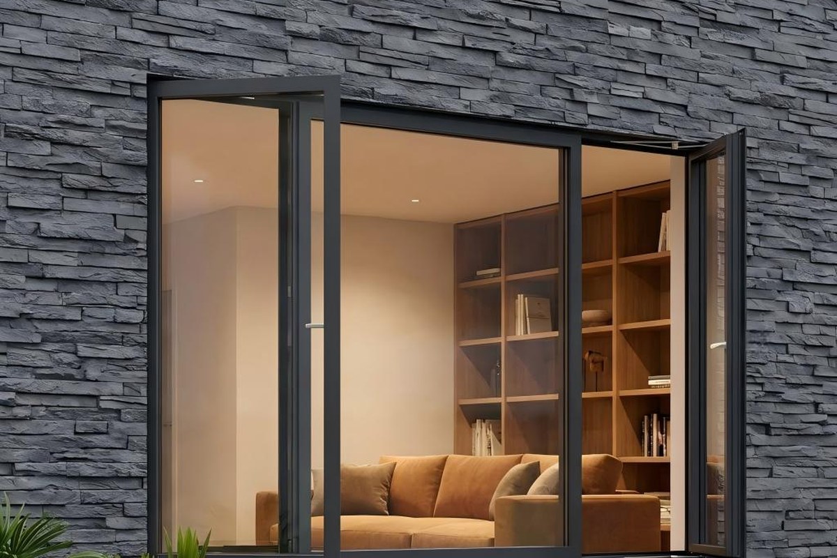 Dark gray aluminum casement windows swinging outward on a stone facade